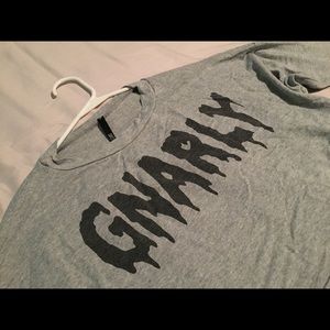 Grey crop top, with wording “Gnarly”